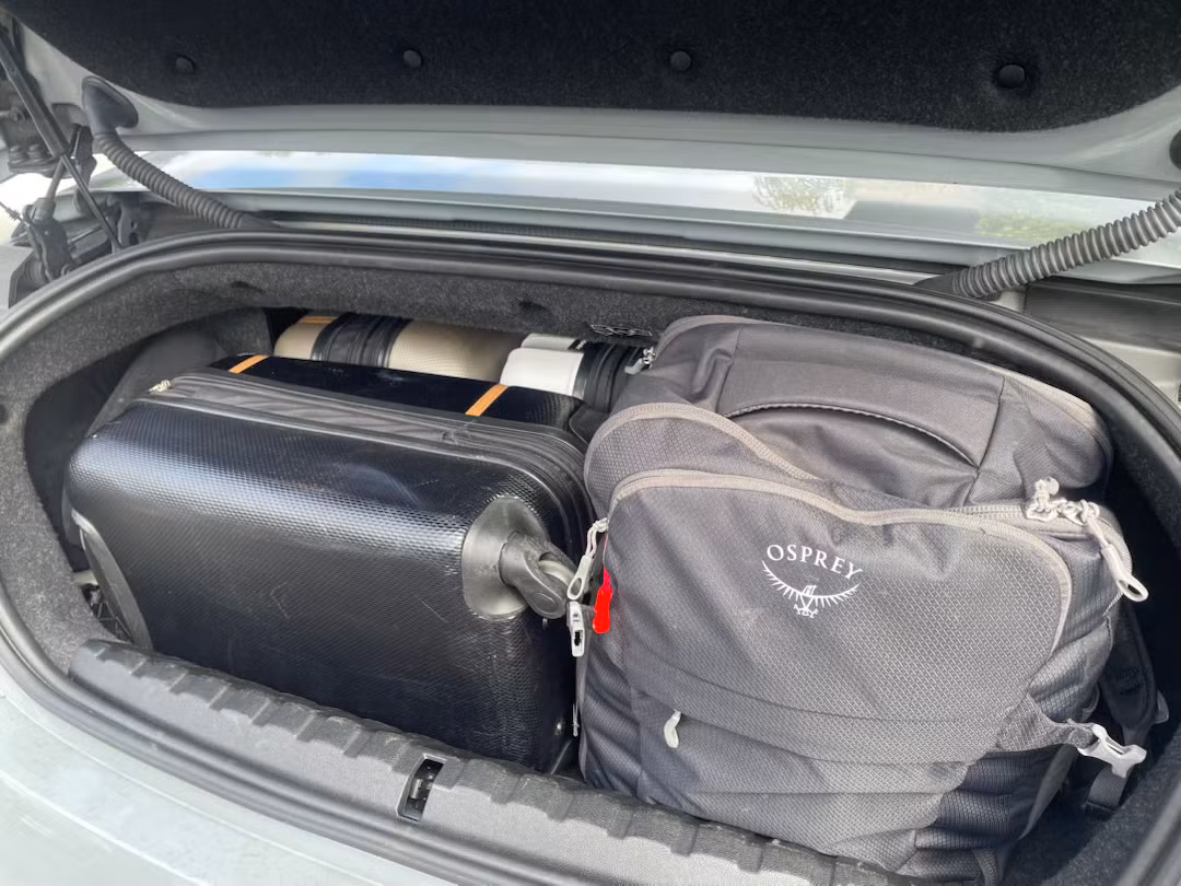 BMW M4 trunk with four roller bags loaded