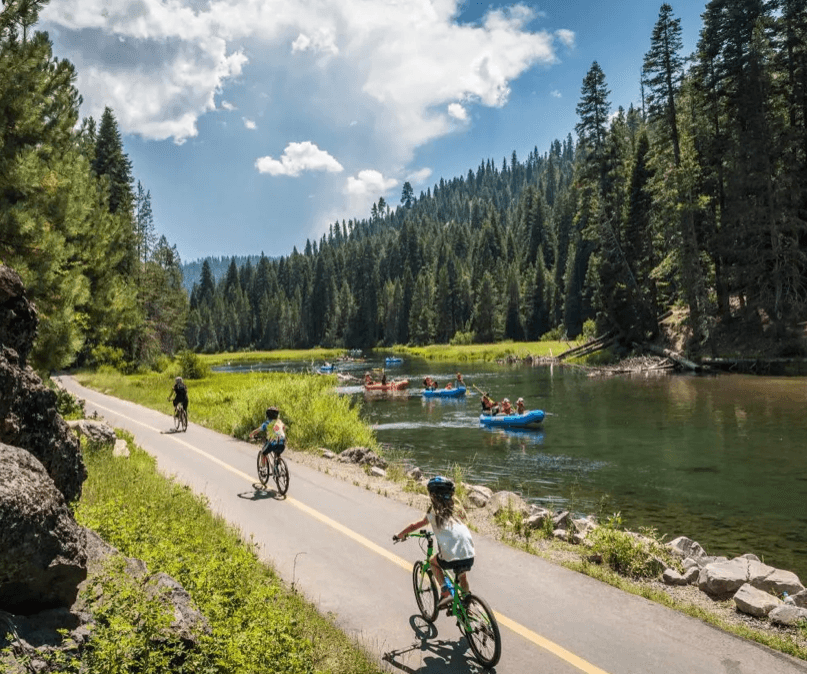 Cyclists and rafters beside the Truckee River near Tahoe City